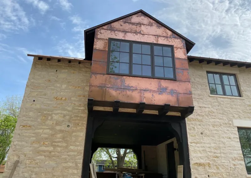Copper metal panel facade on a stone building for Skylight Installation in Waynesville
