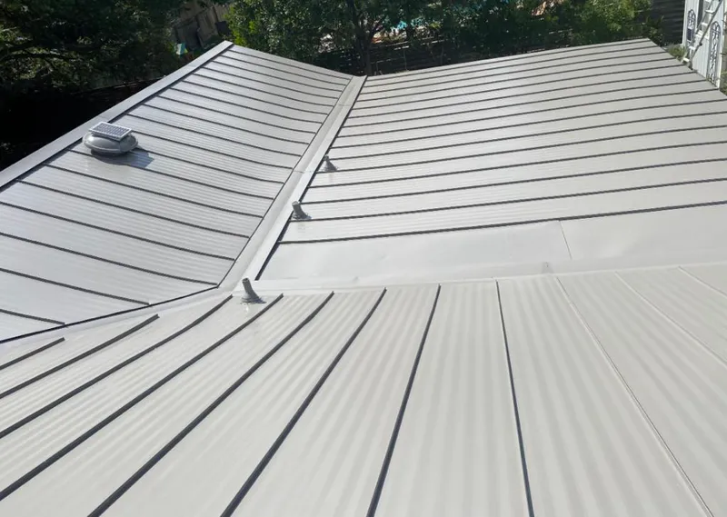 Solar attic fan installed on a metal roof for Roof Ventilation in Waynesville